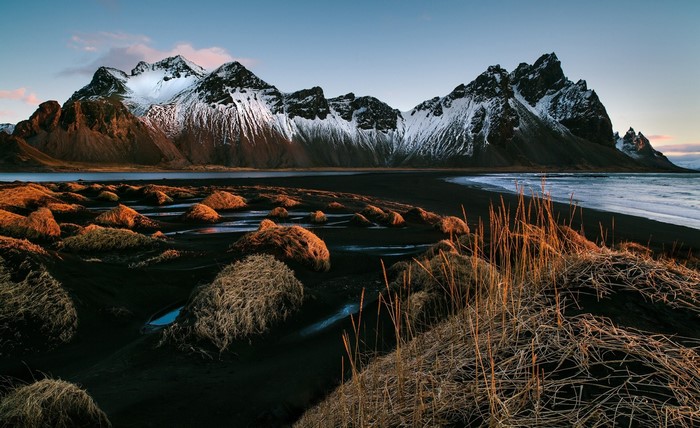 Snow-capped mountains and black sand beach in Iceland