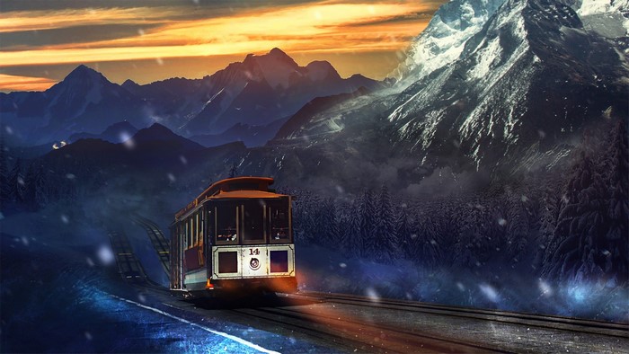 Tram traveling through snowy mountains at sunset