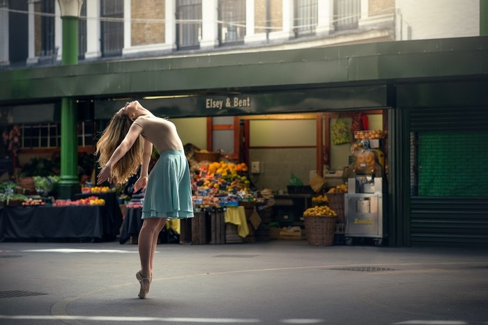Ballerina dancing in front of Elsey & Bent market stall