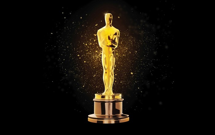 Golden Oscar statue with sparkling particles