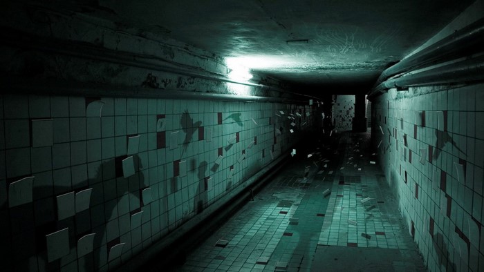 Dark tunnel with peeling tiles and shadows