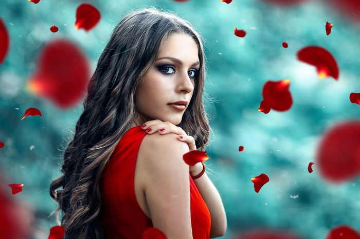 Woman in red dress with rose petals