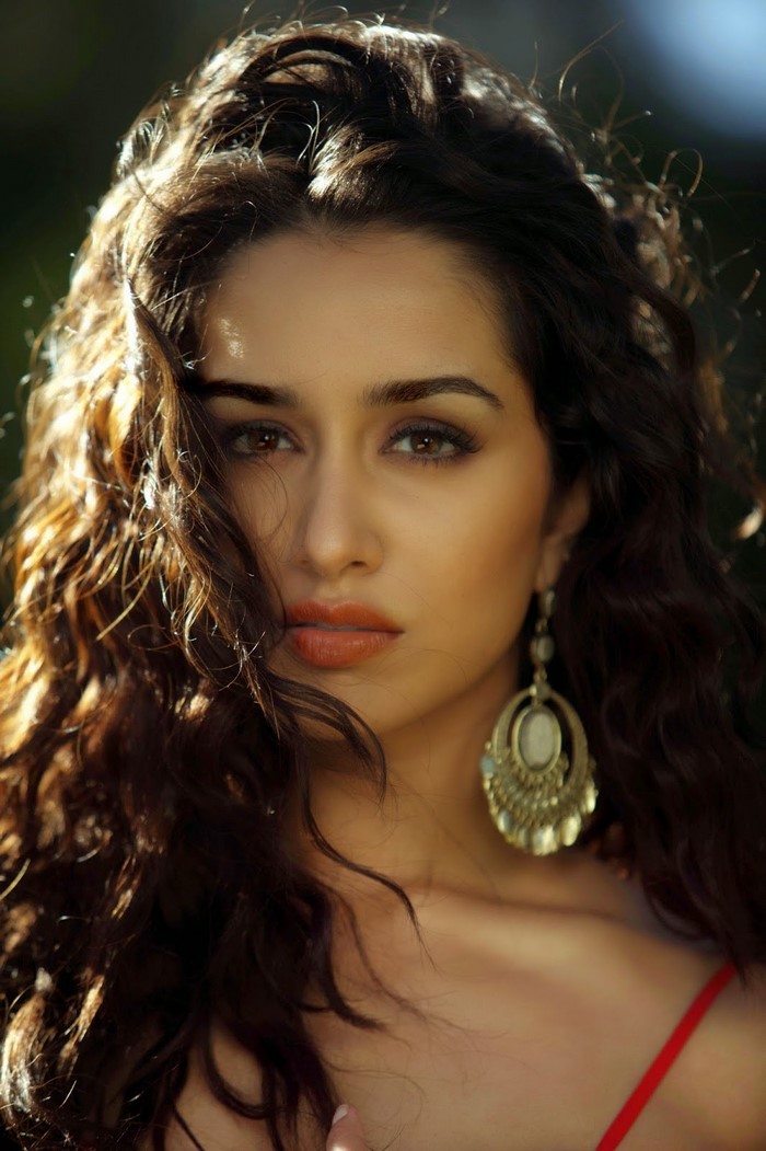 Shraddha Kapoor portrait with long curly hair and earrings