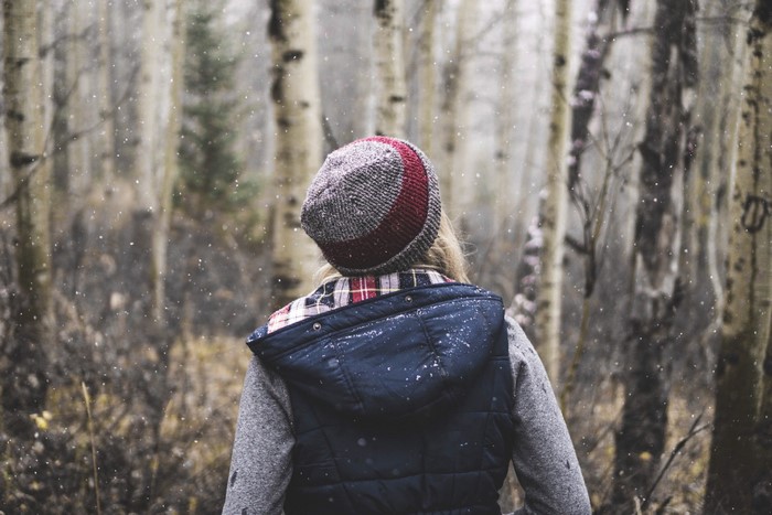 Woman in a forest during snowfall