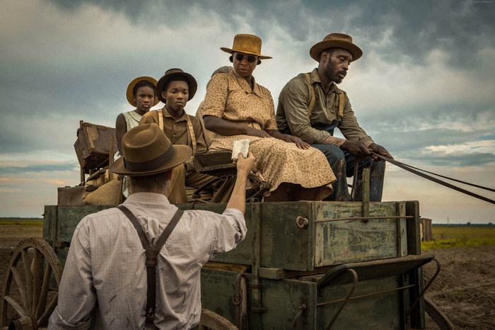Mudbound: A family rides a wagon in a field