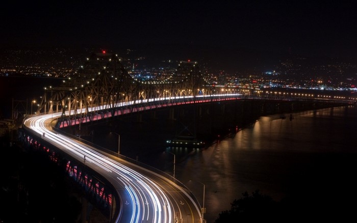 Cityscape at Night with Bridge and Reflections