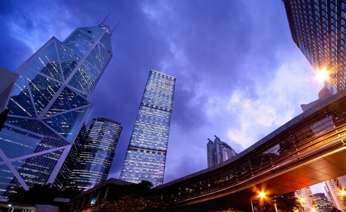Cityscape with illuminated skyscrapers at dusk