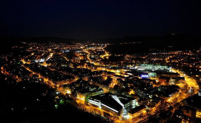 Aerial view of a city at night with illuminated buildings