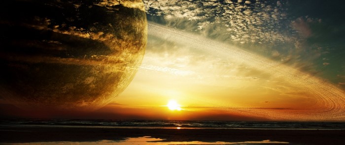 Planet with rings over a beach at sunset