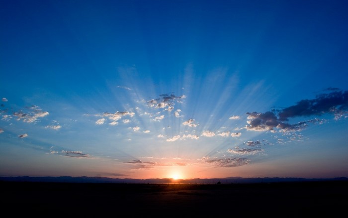 Sunset with sun rays over the horizon