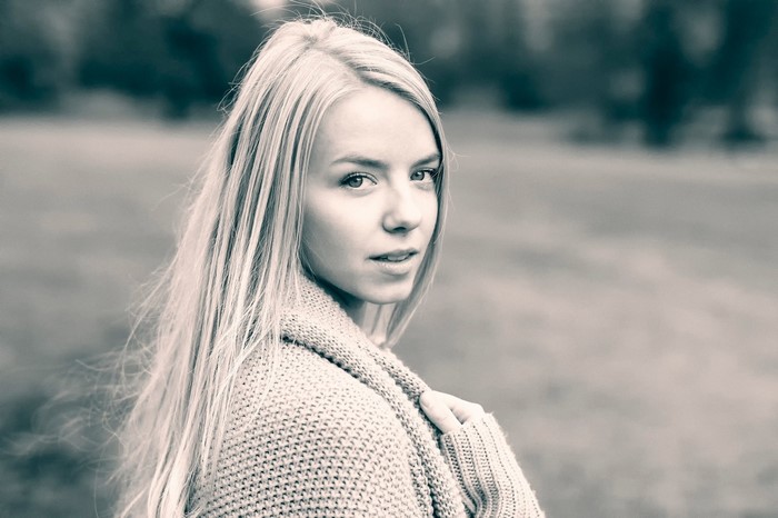 Monochrome portrait of a blonde woman in a sweater