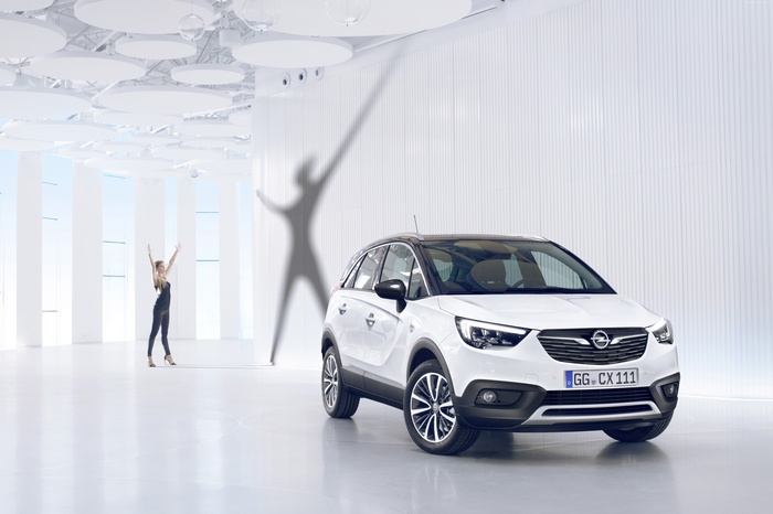 White Opel Crossland X crossover in a modern showroom