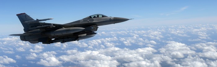 F-16 Fighting Falcon flying over clouds