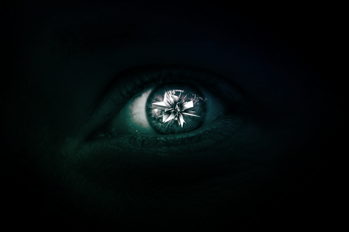 Close-up of a human eye with a fractal reflection
