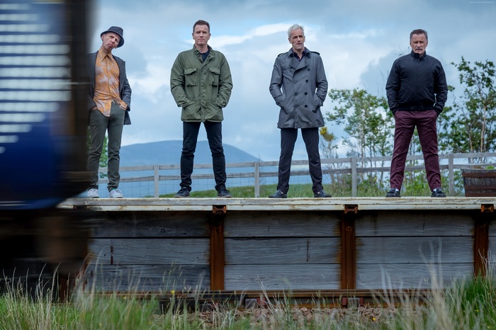 Four men from T2 Trainspotting on a platform