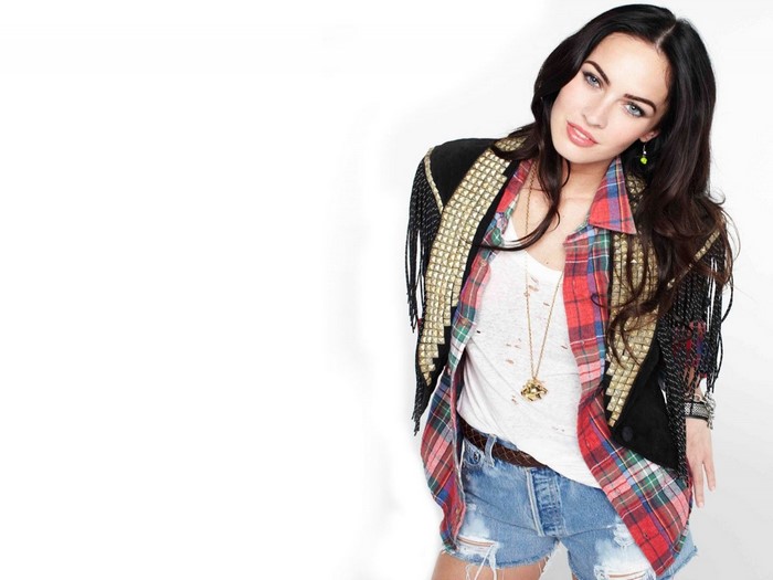Megan Fox wearing a plaid shirt and denim shorts