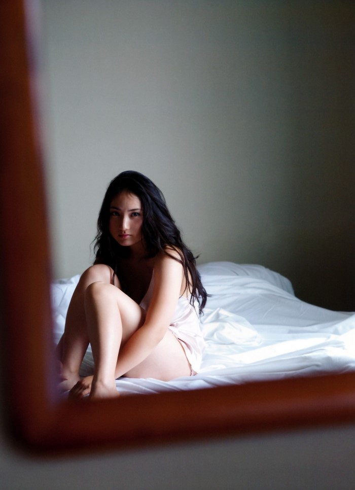 Saaya Irie sitting on a bed