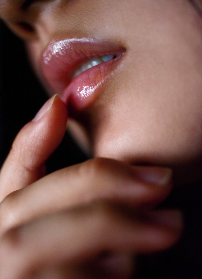 Close-Up of a Person's Lips and Hand