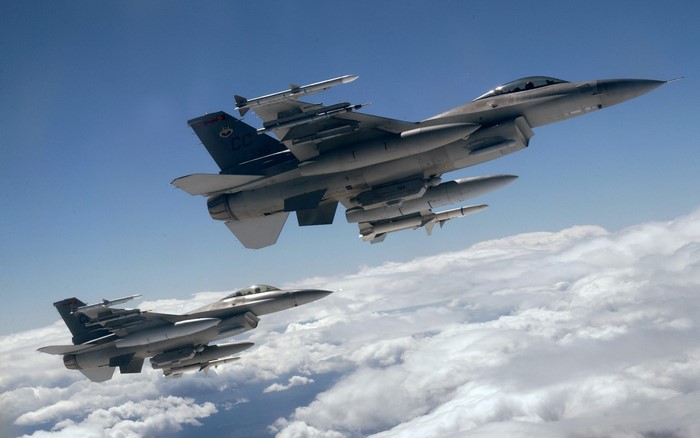 Two F-16 fighter jets flying in formation