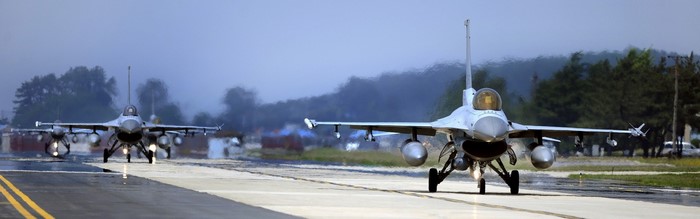Two F-16 fighter jets on a runway