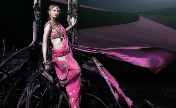 Woman in pink sari with ornate jewelry