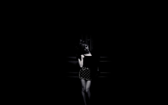 Monochrome portrait of a woman in a dark setting