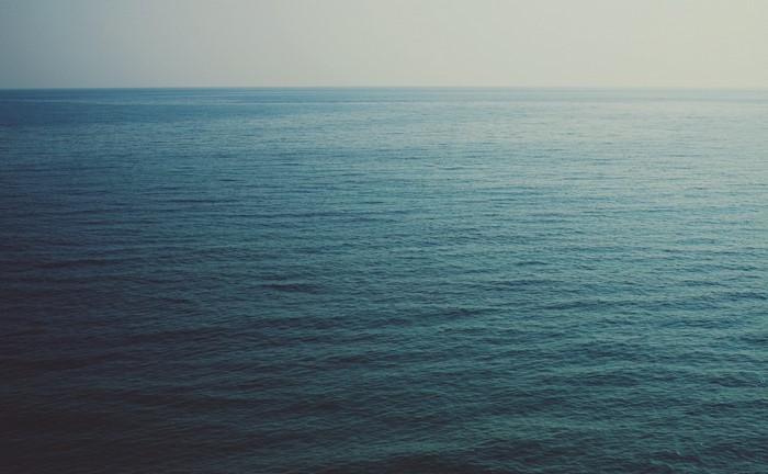 Ocean horizon with gentle waves under a pale sky