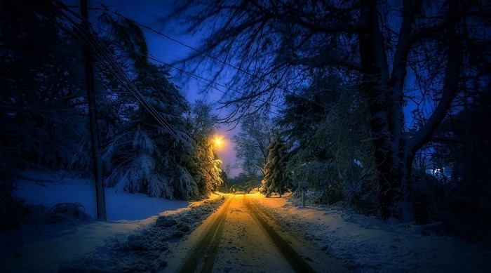 Snowy road at night with street light
