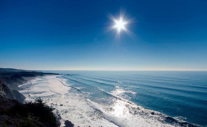 Sun shining over the ocean and coast