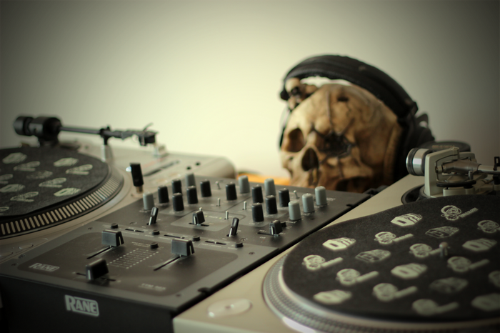 DJ turntables and mixer with skull and headphones