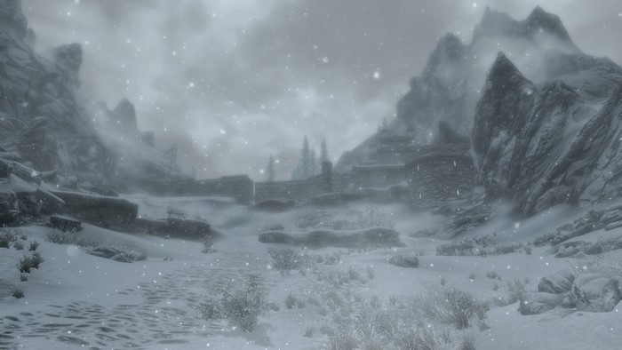 Snowy landscape with mountains and a fort in The Elder Scrolls V Skyrim