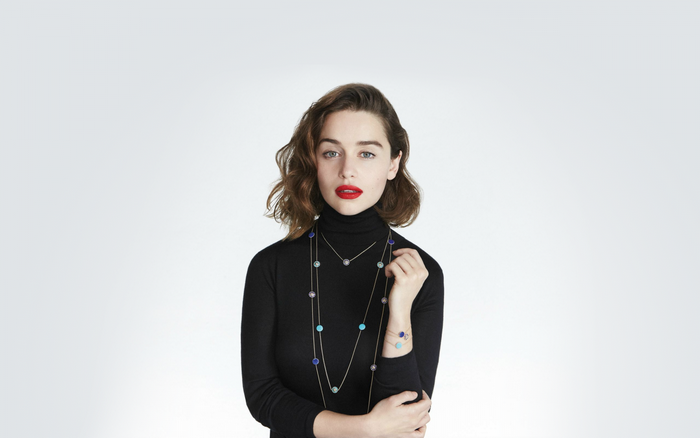 Emilia Clarke wearing a black turtleneck and jewelry