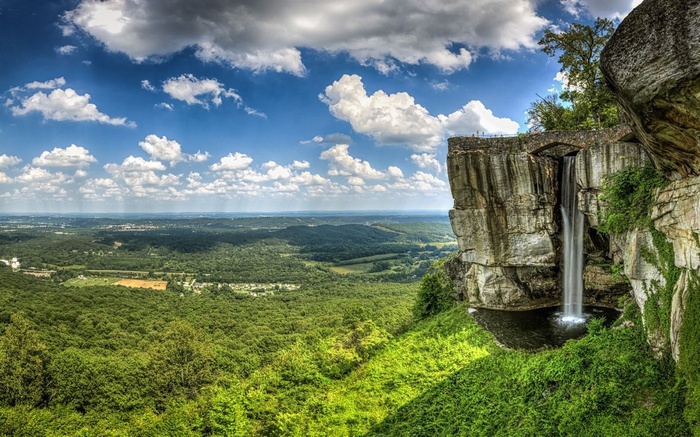 Waterfall cascading from a cliff overlooking a valley