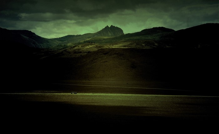 Dark landscape with mountains and a lake
