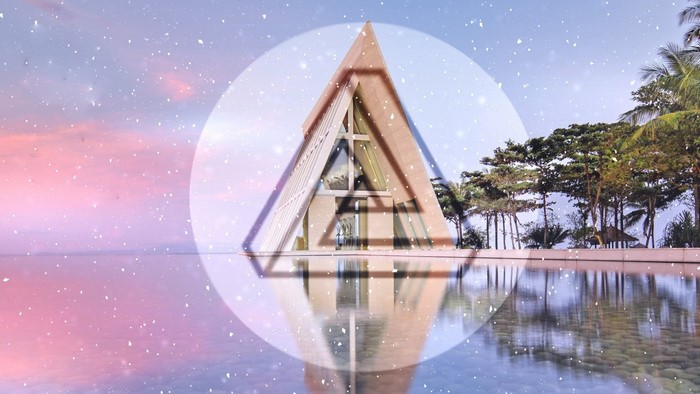A-frame chapel reflected in water with snow