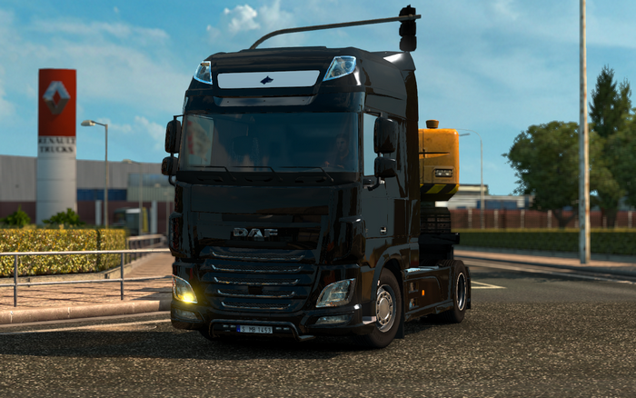 Black DAF truck with yellow trailer
