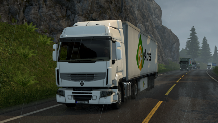 White truck with eAcres trailer on a wet road