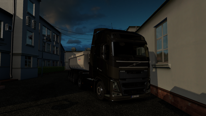 Black Volvo Truck with Trailer in Industrial Area