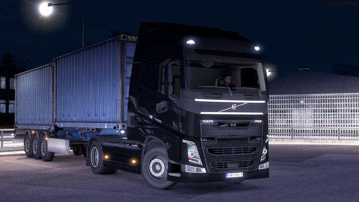 Volvo FH16 truck with container trailer at night