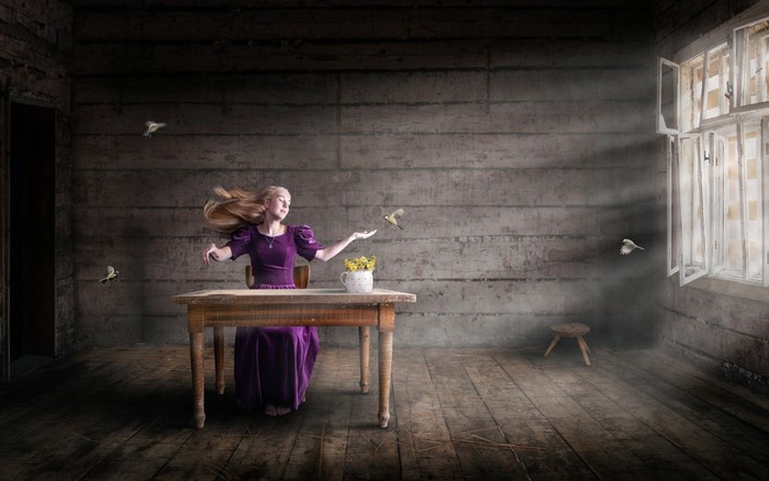 Woman in purple dress with birds in a dark room