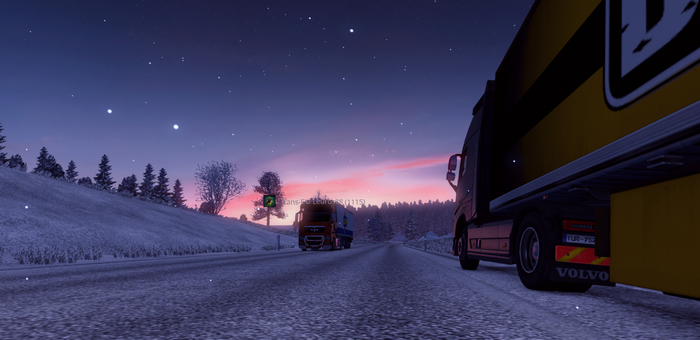 Trucks on a snowy road at dusk