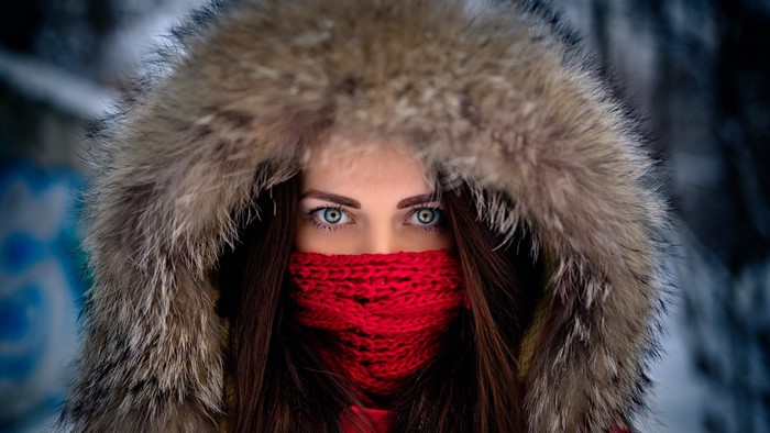 Woman in fur hood and red scarf