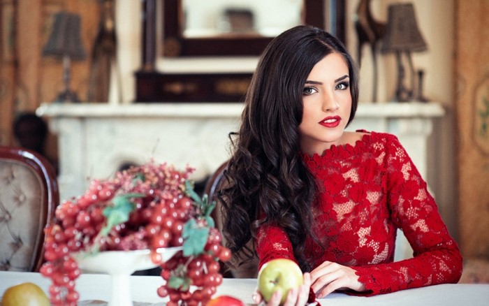 Woman in red lace dress with fruit