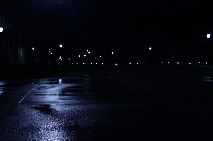Wet street at night with streetlights