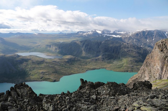 Turquoise lakes and snow-capped mountains from a rocky viewpoint