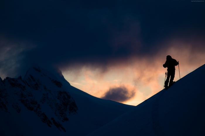 Xavier De Le Rue skiing in Alaska mountains at sunset