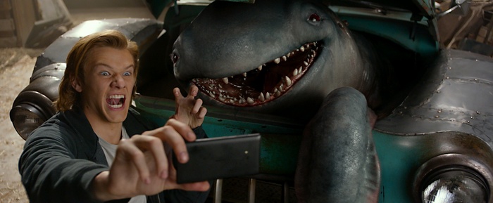 Lucas Till and a shark creature taking a selfie
