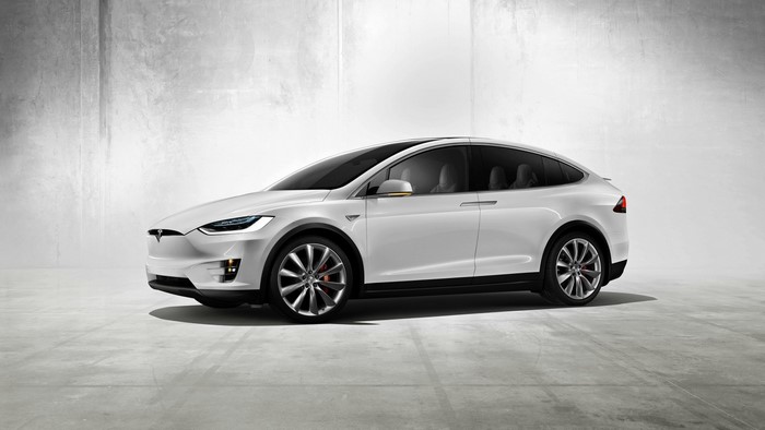 White Tesla Model X parked on concrete floor