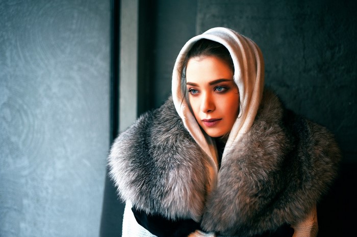 Woman wearing a fur coat and hood
