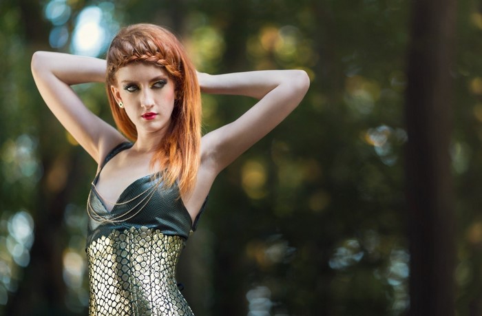 Redheaded Woman Posing Outdoors in Metallic Dress